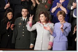 Safia Taleb al-Suhail, leader of the Iraqi Women's Political Council, second on right, displays a peace sign as other guests applaud during President George W. Bush's State of the Union speech at the U.S. Capitol, Wednesday, Feb. 2, 2005. Also pictured are, from left, Kindergarten teacher Lorna Clark of Santa Theresa, New Mexico, Army Staff Sergeant Norbert Lara, and Laura Bush. White House photo by Paul Morse.